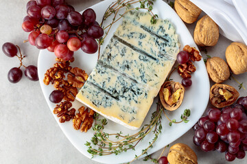 Gorgonzola cheese with walnuts, red grapes, and thyme.