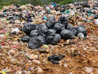 Pile of domestic garbage in landfill background. Stock photo.