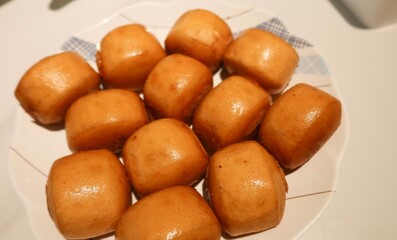 close up of many Chinese deep fried plain bun or mantou on a white plate