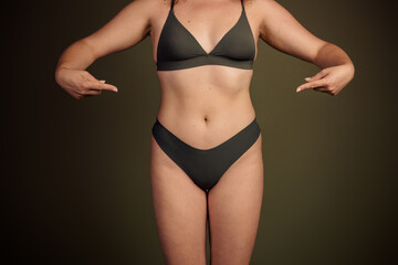 Young woman in minimal lingerie showcasing natural beauty and self confidence with a focus on body...