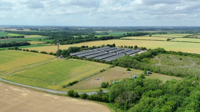 Aerial drone view of agriculture barns chicken coops farm land rural setting near Scunthorpe England UK