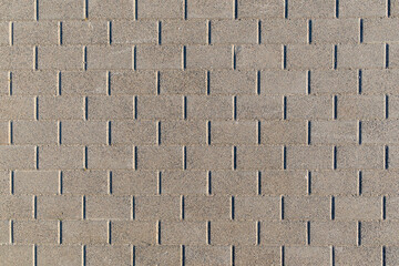 Top view of textured concrete pavement with a clean, repeating brick pattern. Urban sidewalk...