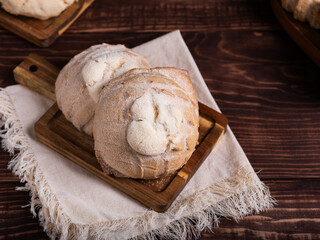 Concha breads, dusted with sugar, rest on a rustic wooden board