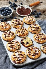 tasty blueberry muffins with lemon chocolate glaze