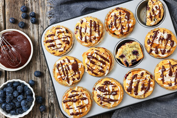 tasty blueberry muffins with lemon chocolate glaze