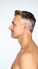 Obraz premium Profile of a Smiling Middle-Aged Man with Graying Hair Showing Healthy Skin and Physique.