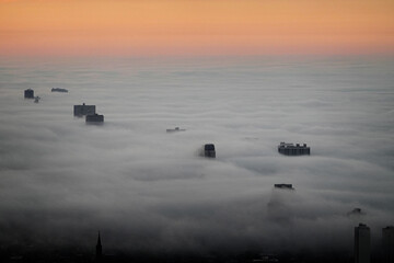 View from Willis Tower or Sears Building in Chicago with Fog Clouds Rolling in on the City Buildings