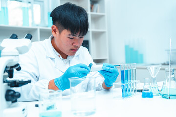 Fototapeta premium Scientist using micropipette for laboratory experiment in modern science lab. Concept of chemical research, liquid analysis, biotechnology, precision science, healthcare and diagnostics.