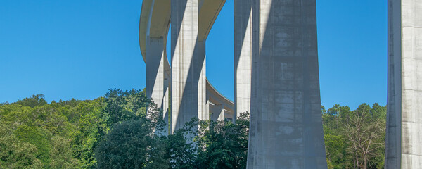 Concrete viaduct bridge crossing forest landscape