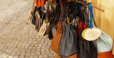 Bright handmade leather waist bags at an exhibition at the medieval street market in Bavaria