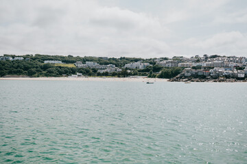 A calm body of water with a few boats floating on it
