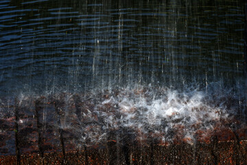 Water splashing on a stone wall, closeup of photo.