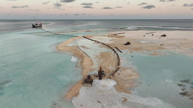 Aerial view of land reclamation with ship, Maldives.