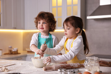 Cooking recipe. Cute children mixing dough for cookies at table in kitchen