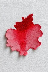Red watercolor blot on textured paper. Abstract art.