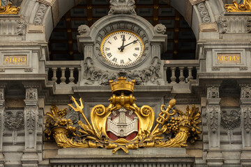 The front facade of the clock and the symbol in Antwerp central station building 