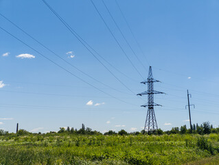A field of green grass and power lines in the distance