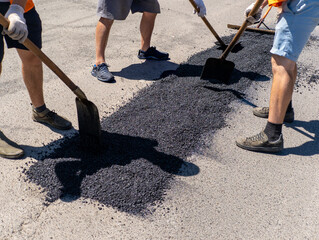 A group of men working on a road with shovels