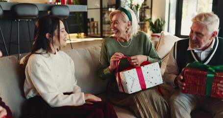 Christmas, open or mature mom with gift for appreciation, support or festive celebration. Happy, family or woman with xmas present for gratitude, senior parent or love for holiday tradition in home - Powered by Adobe