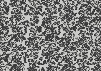 Damask pattern of dark foliage on a pale gray backdrop dense and stylized