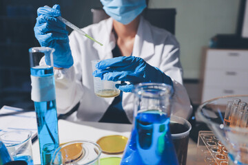 Scientist pipetting medical samples into microplate in laboratory