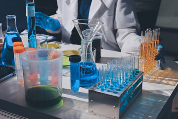 Scientist pipetting medical samples into microplate in laboratory