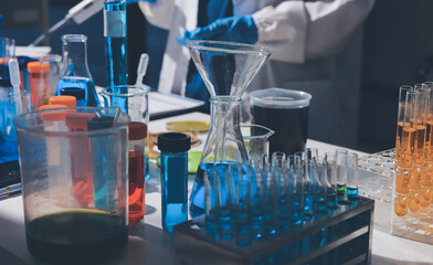 Scientist pipetting medical samples into microplate in laboratory