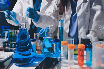 Scientist pipetting medical samples into microplate in laboratory