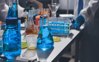 Scientist pipetting medical samples into microplate in laboratory