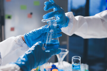 Scientist pipetting medical samples into microplate in laboratory