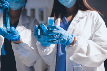 Scientist pipetting medical samples into microplate in laboratory