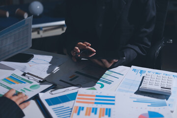 Group of business women working on a financial data expenses document.