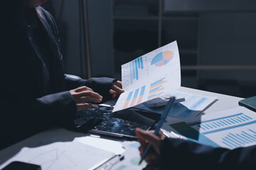 Group of business women working on a financial data expenses document.