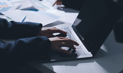 Group of business women working on a financial data expenses document.