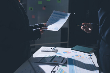 Group of business women working on a financial data expenses document.