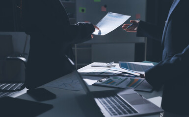 Group of business women working on a financial data expenses document.
