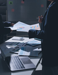Group of business women working on a financial data expenses document.