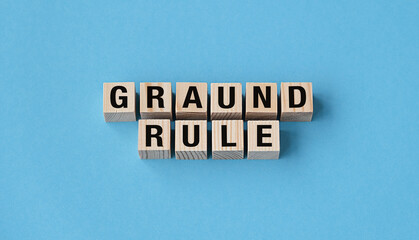 A wooden block with the letters GRAND RULE written on it