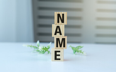 A stack of wooden blocks with the letters Name on top