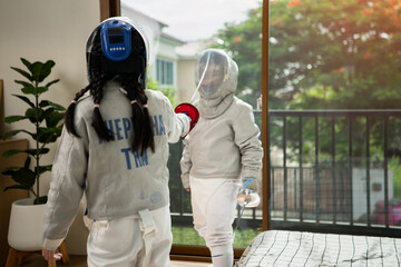 Before the tournament day, a boy and girl dressed in fencing gear are rehearsing in gym