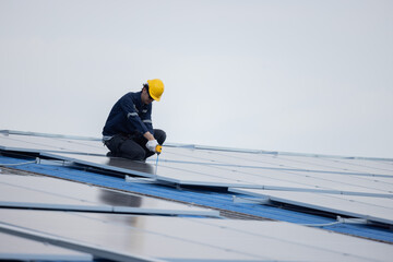 Engineer repair solar panel on the factory rooftop