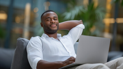 Man planning his month while using a laptop in a thoughtful pose