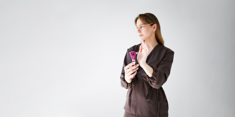 Banner of female pediatrician holding an otoscope and gesturing during demonstration. Concept of...