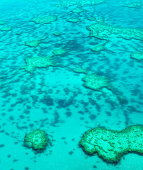 Aerial view of underwater reefs and Heart Reef of the Great Barrier Reef, the world's largest coral reef system with its clear waters, near Whitsundays Islands, Coral Sea, Australia 2020.