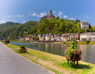 View of Reichsburg on hill above Moselle river and colorful houses in Cochem, Germany