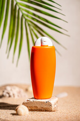 Sunblock or sunscreen in cosmetic tube on beach sand and beige background. Summer vacation and skin care concept with starfish and sea shells, spf uv-protect cosmetics. Skin health. High quality photo