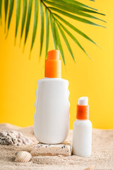 Sunblock or sunscreen in cosmetic tube on beach sand and beige background. Summer vacation and skin care concept with starfish and sea shells, spf uv-protect cosmetics. Skin health. High quality photo