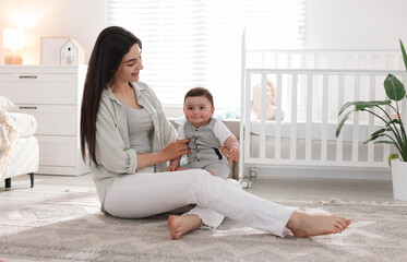Mother with her cute baby at home. Space for text