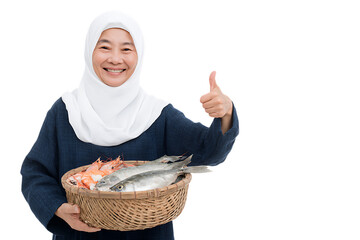 Smiling woman in hijab holding a basket of fresh fish and seafood, giving thumbs up.
