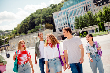 Buddies walking outdoors enjoying summer day embracing friendship and urban exploration in city